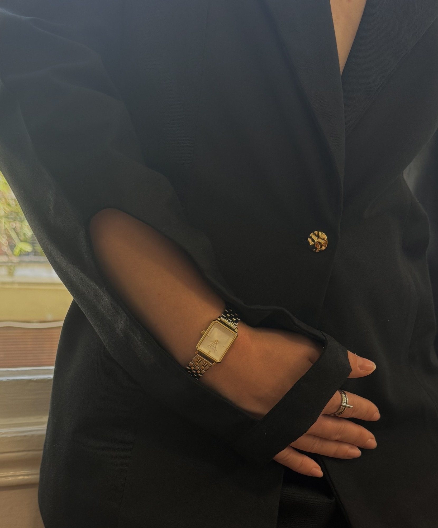 Ponte detail: slit sleeve and sculpted gold button